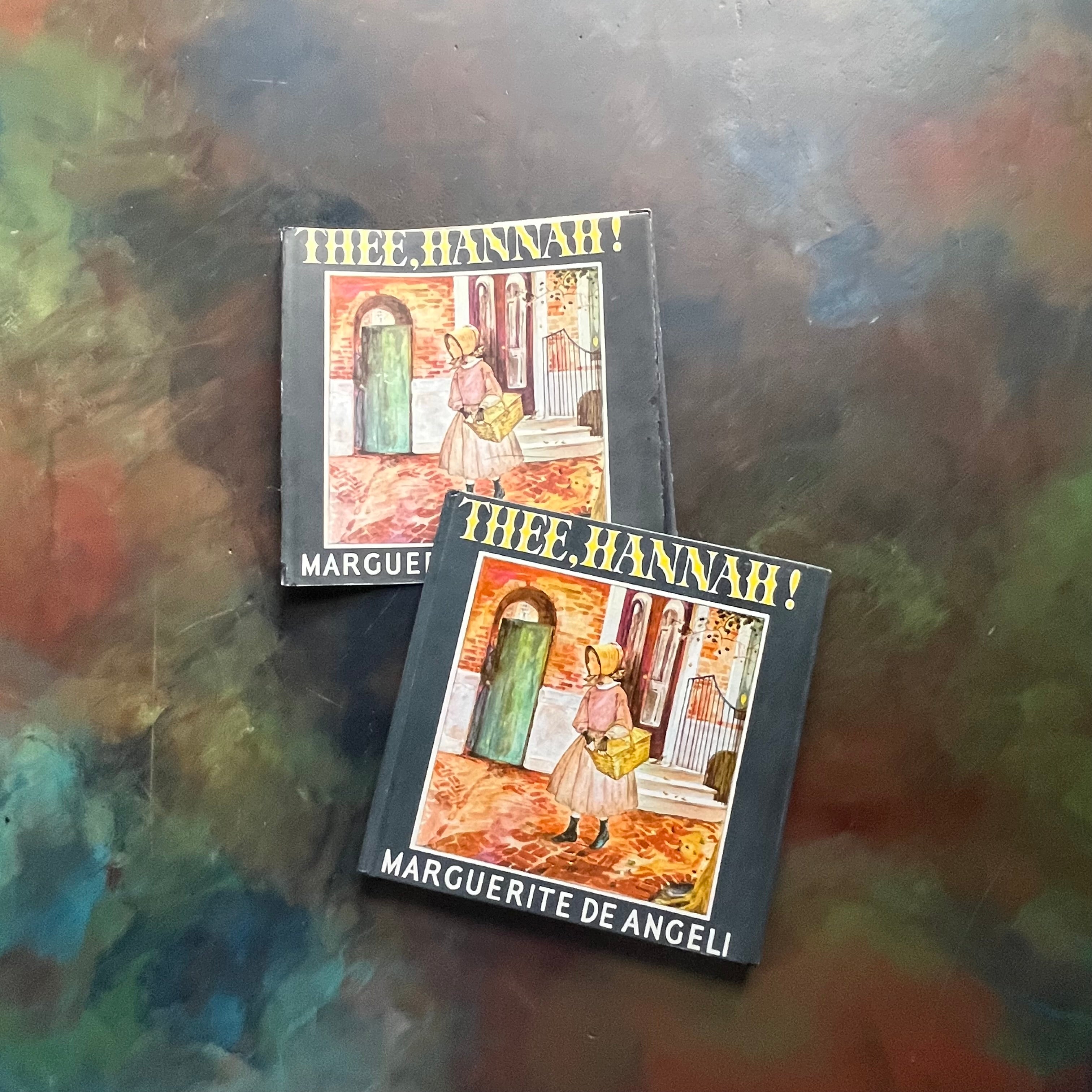 Thee, Hannah! written and illustrated by Marguerite de Angeli-antique children's book-PA Quaker history-vintage children's picture book-view of the front cover depicting Hannah walking with a shopping basket on a cobblestoned street in Colonial Philadelphia.