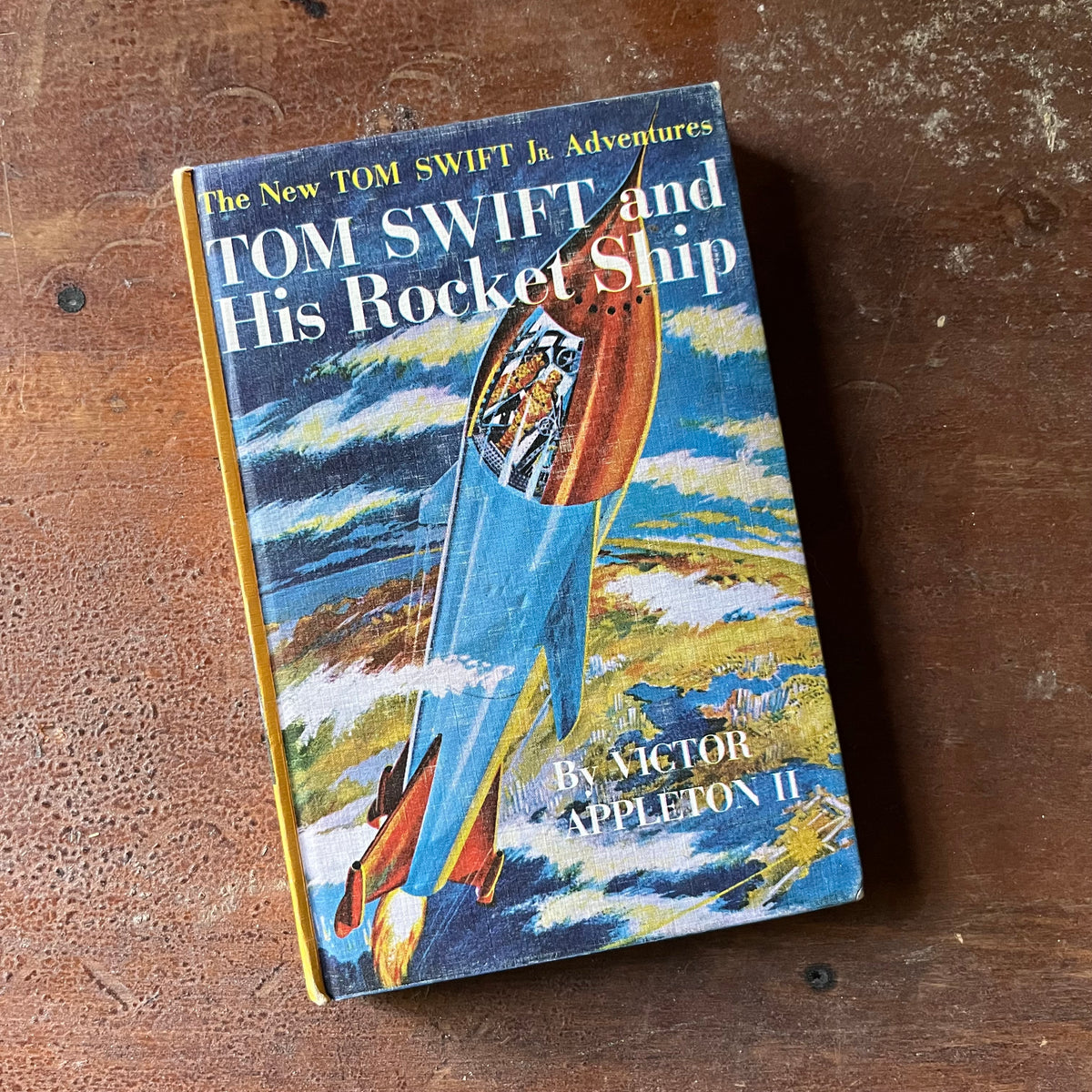 vintage children's adventure chapter books for boys, The New Tom Swift Jr. Adventure Series Book - Tom Swift and His Rocket Ship written by Victor Appleton II with illustrations by Graham Kaye - view of the front cover depicting Tom Swift in his rocket ship