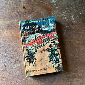 vintage children's chapter book, vintage adventure book for boys, homeschool library, The New Tom Swift, Jr. Adventures Book - Tom Swift and His Triphibian Atomicar written by Victor Appleton II with illustrations by Charles Brey - view of the front cover with an illustration of the triphibian atomicar along with men on horseback