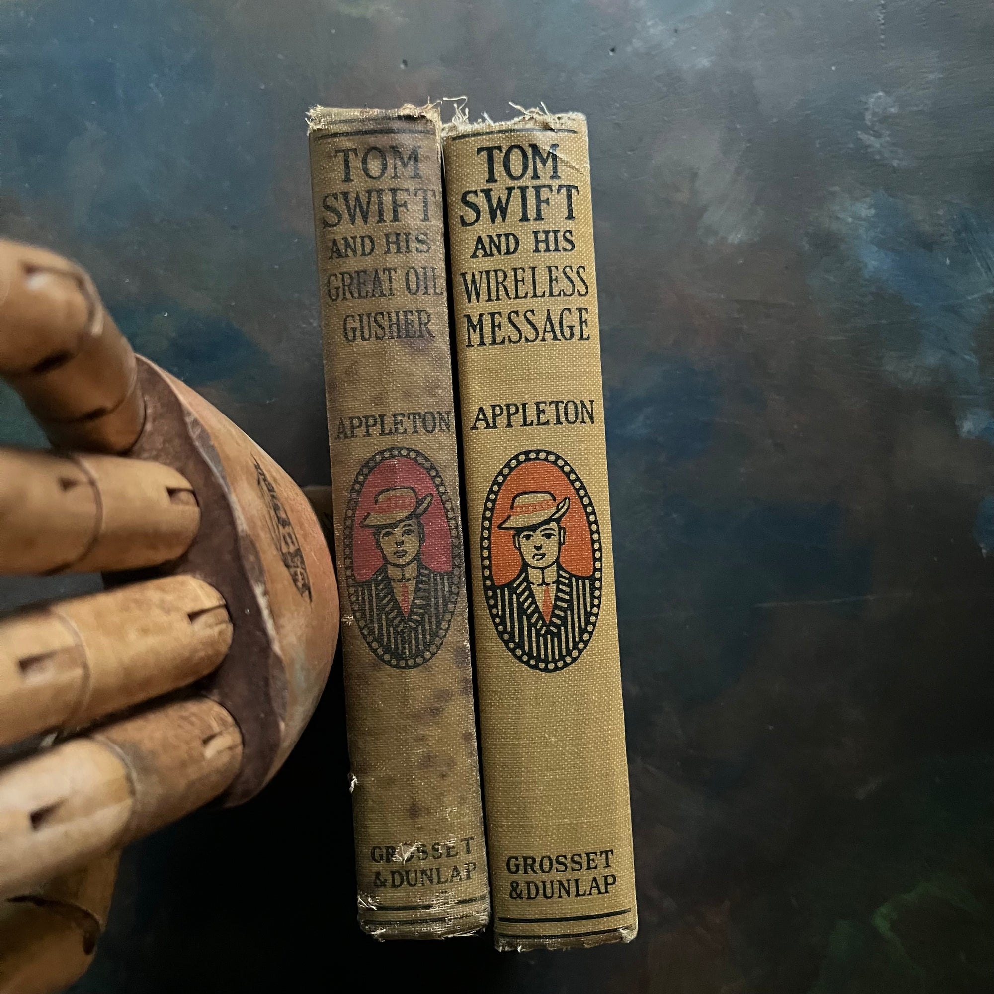 Tom Swift and His Great Oil Gusher and Tom Swift and His Wireless Message written by Victor Appleton-antique science fiction books-view of the spines