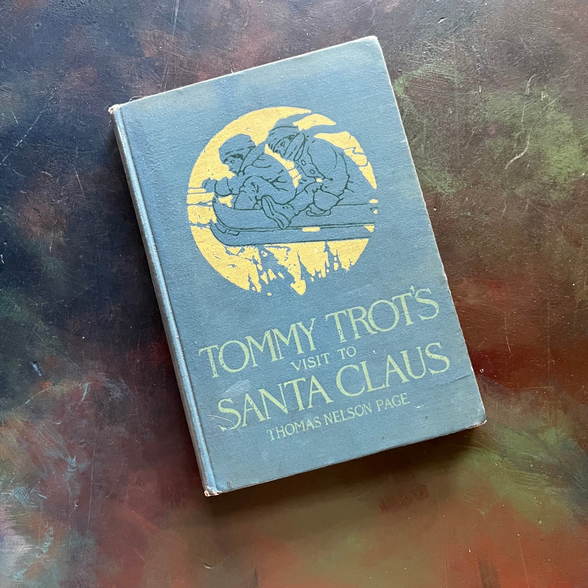 Tommy Trot's Visit to Santa Claus by Thomas Nelson Page-1908 Edition-vintage children's chapter book-Christmas book for children-view of the front cover with children on a sled flying through the air