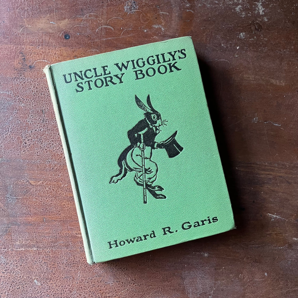 vintage children's storybook, antique children's book - Uncle Wiggily's Story Book written by Howard R. Garis with illustrations by Lansing Campbell - view of the embossed front cover with an illustration of Uncle Wiggily in black on a green background