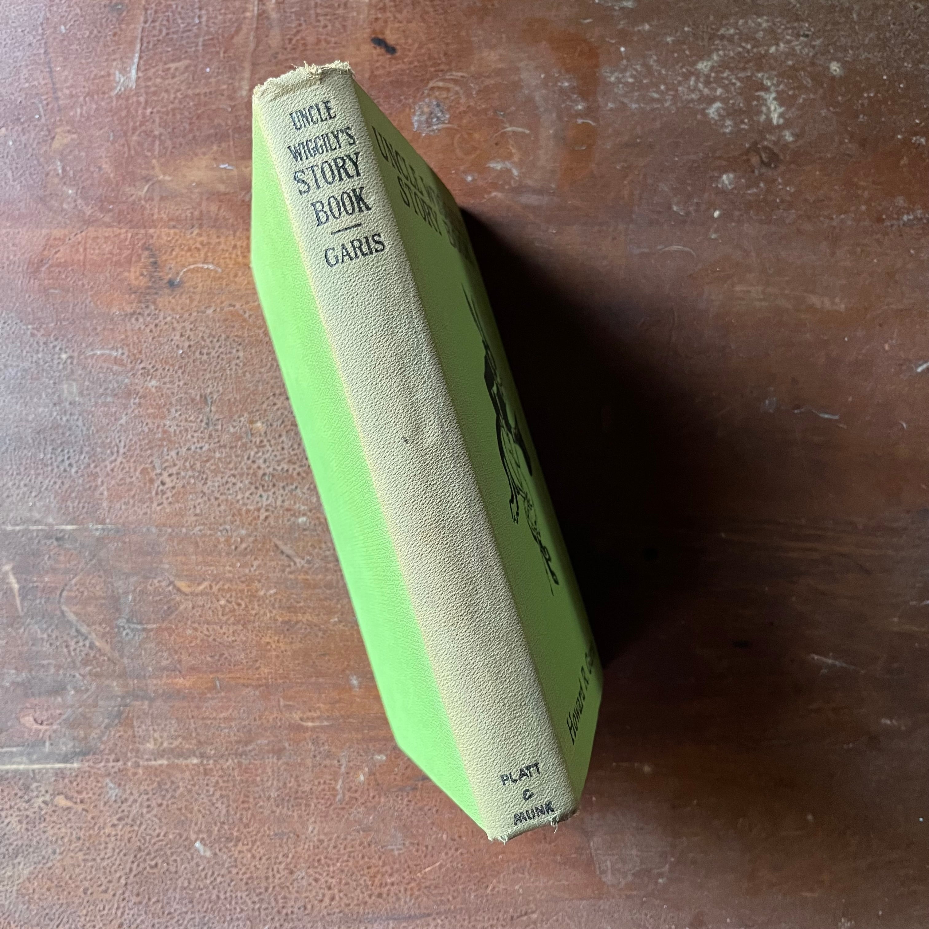 vintage children's storybook, antique children's book - Uncle Wiggily's Story Book written by Howard R. Garis with illustrations by Lansing Campbell - view of the spine which has faded to a gray (from green) from years of sitting on a bookshelf