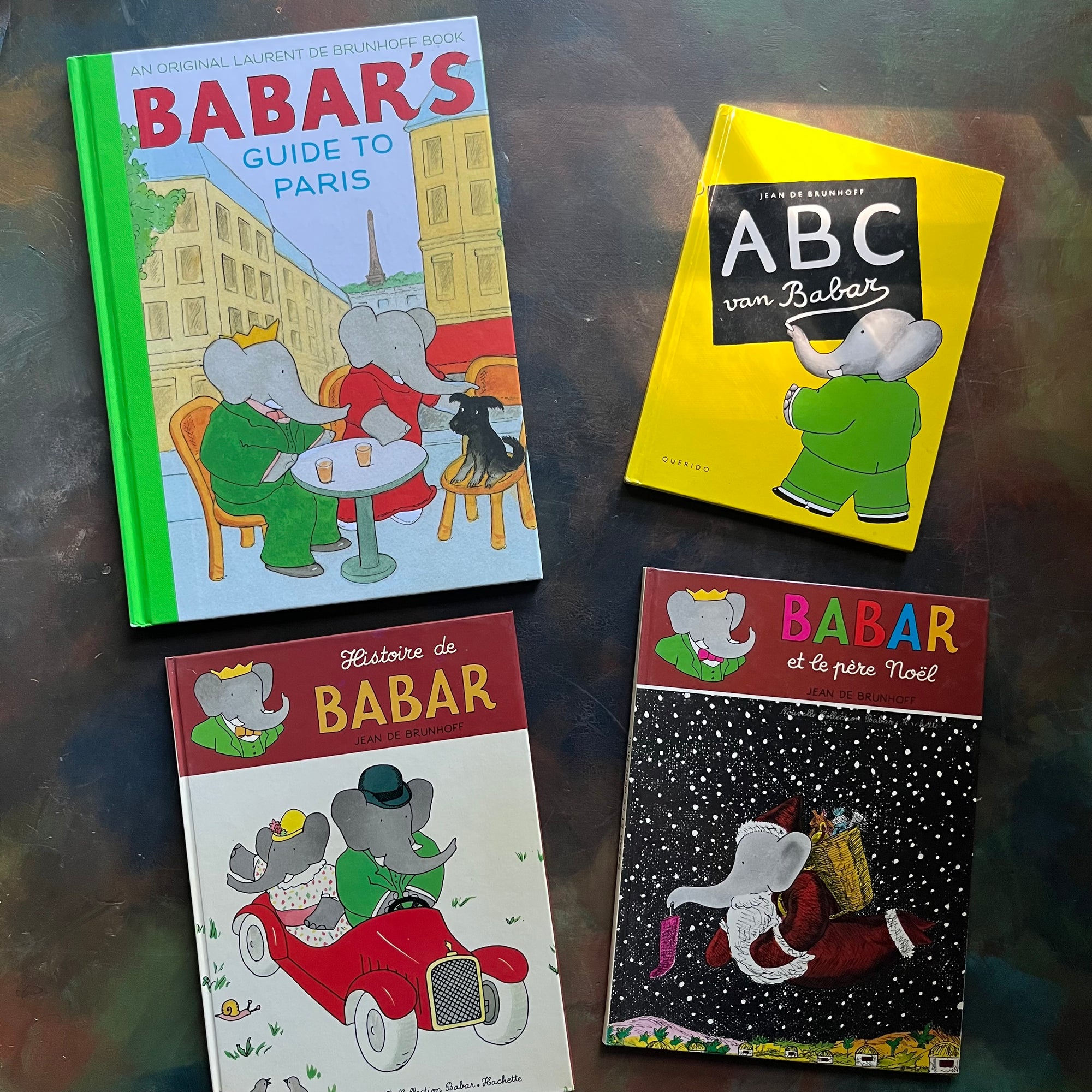 Vintage Babar Books-Four-Book French & Paris Collection by Jean de Brunhoff-Babar's Guide to Paris by Laurent De Brunhoff-Jean De Brunhoff ABC Van Babar (Dutch book)-Histoire de Babar-Babar et le Pere Noel-vintage picture books-foreign languages-view of the front covers - all depicting images of Babar
