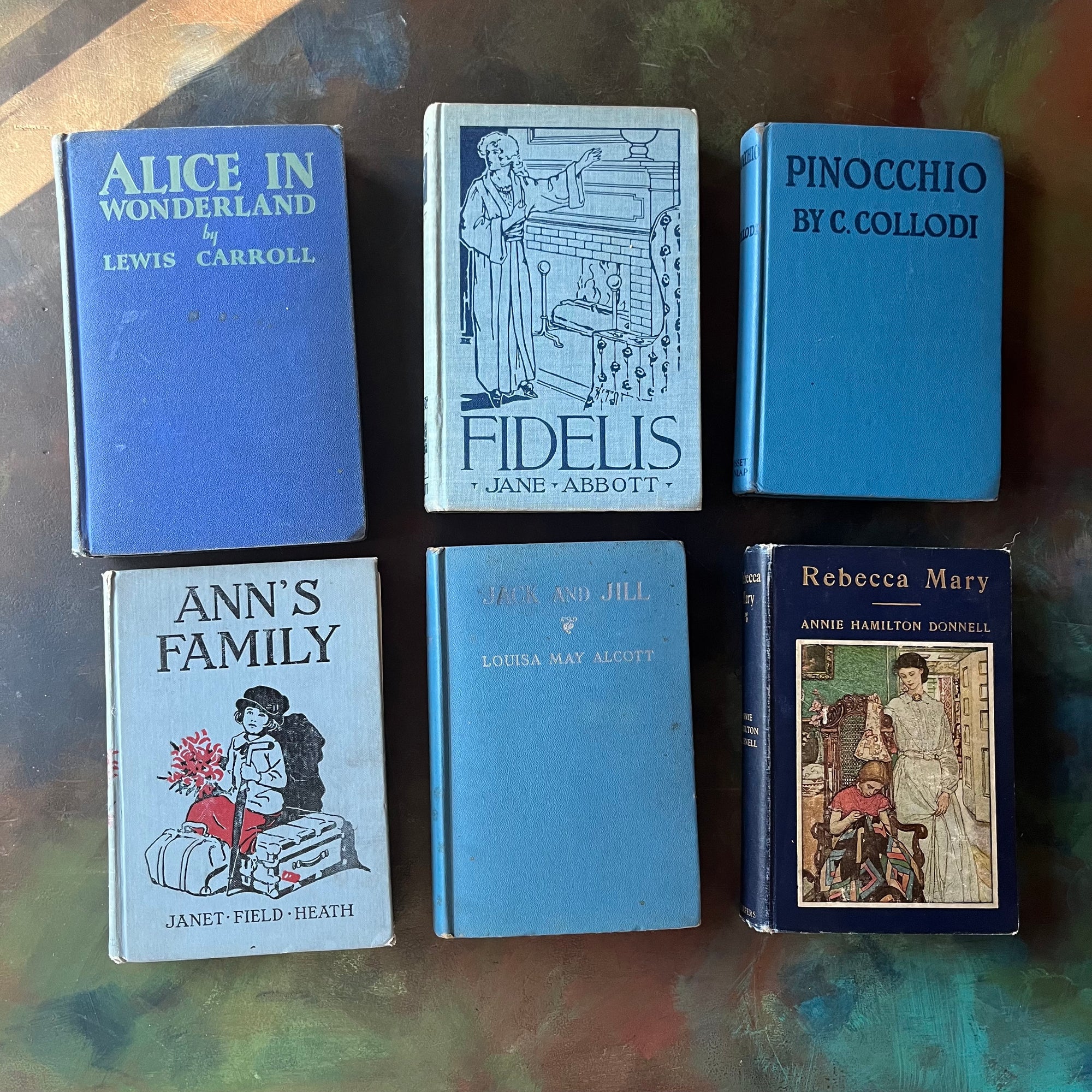 Vintage Blue Book Stack-classic children's literature-Alice in Wonderland-Pinocchio-Jack & Jill-Fidelis-Ann's Family-view of the spines-view of the front covers