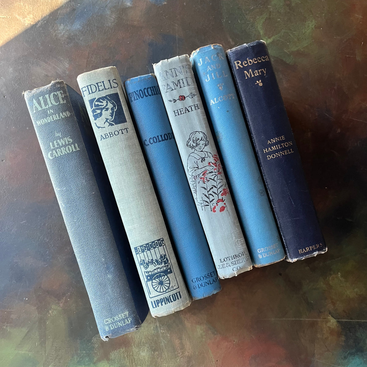 Vintage Blue Book Stack-classic children's literature-Alice in Wonderland-Pinocchio-Jack & Jill-Fidelis-Ann's Family-view of the spines