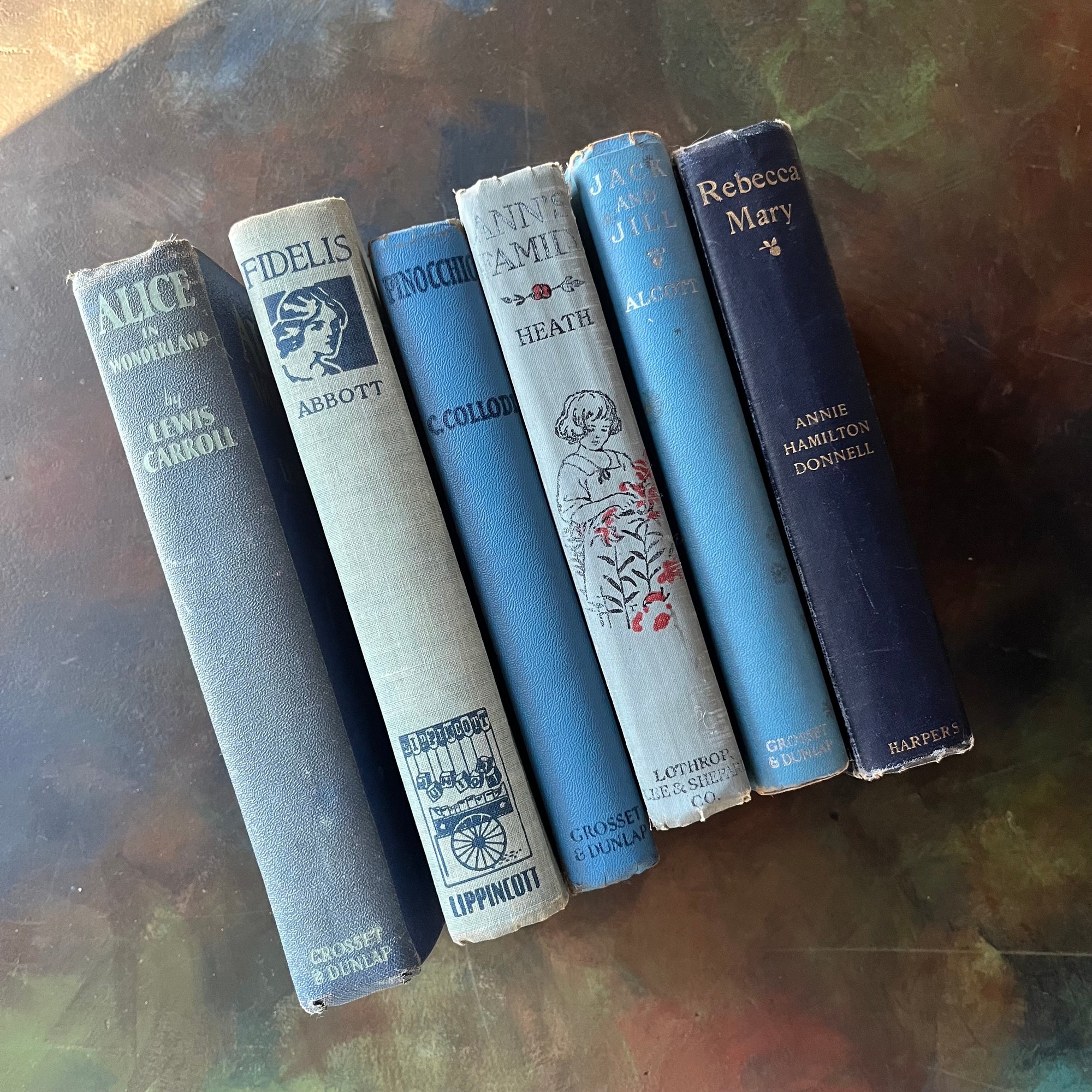 Vintage Blue Book Stack-classic children's literature-Alice in Wonderland-Pinocchio-Jack & Jill-Fidelis-Ann's Family-view of the spines