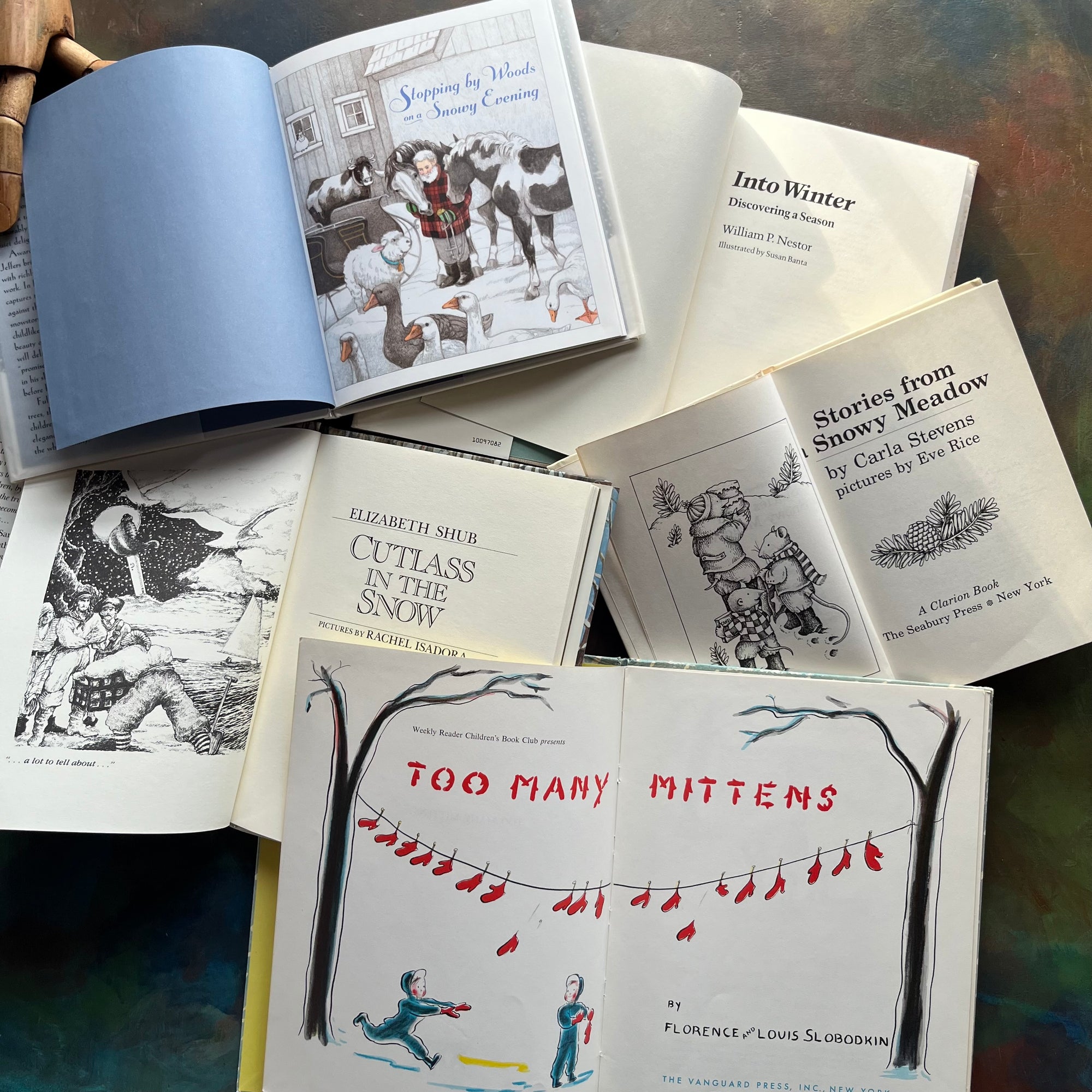 Vintage Children's Winter Themed Picture Books-Stories From A Snowy Meadow-Too Many Mittens, Cutlass in the Snow, Into Winter, Stopping by Woods in a Snowy Evening by Robert Frost-view of the title pages