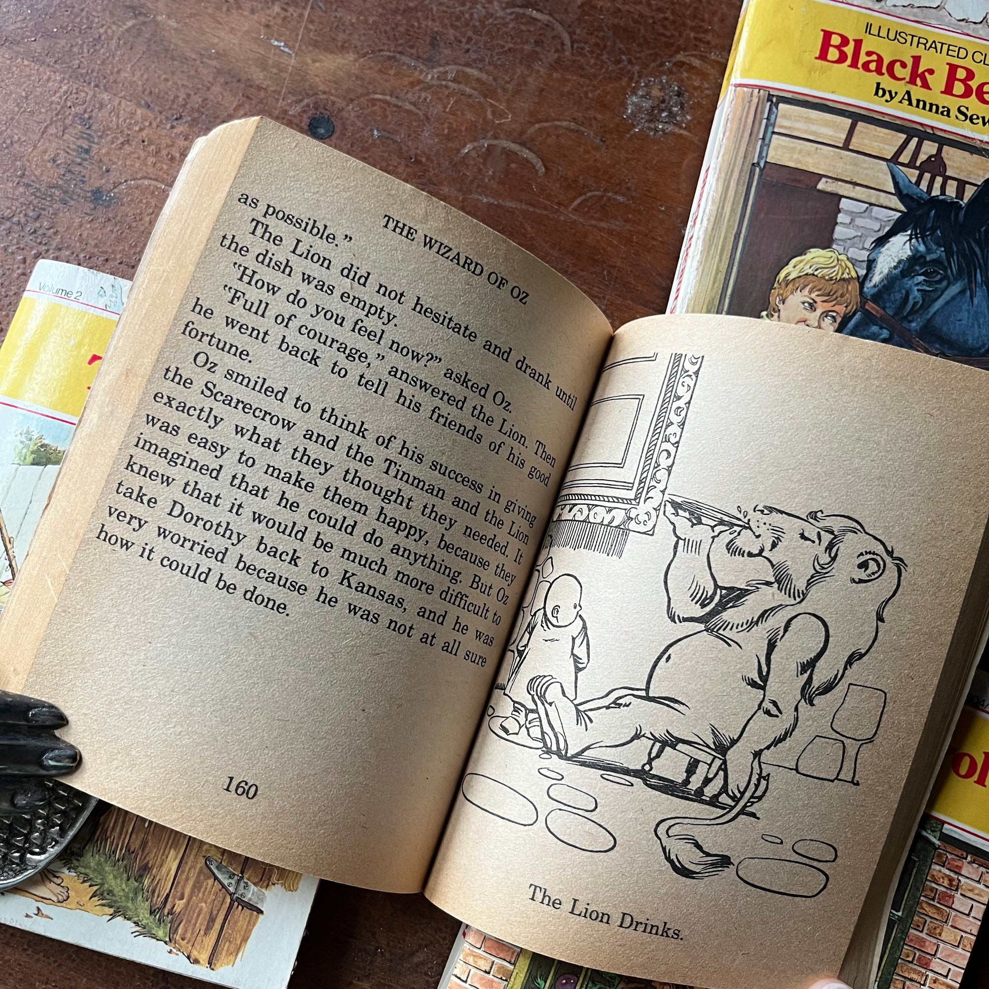 vintage children's chapter books, McDonald's Illustrated Classics - Set of 4 McDonald's Illustrated Classics Books:  The Wizard of Oz, The Adventures of Tom Sawyer, Black Beauty & A Christmas Carol - view of a black & white illustration in The Wizard of Oz.