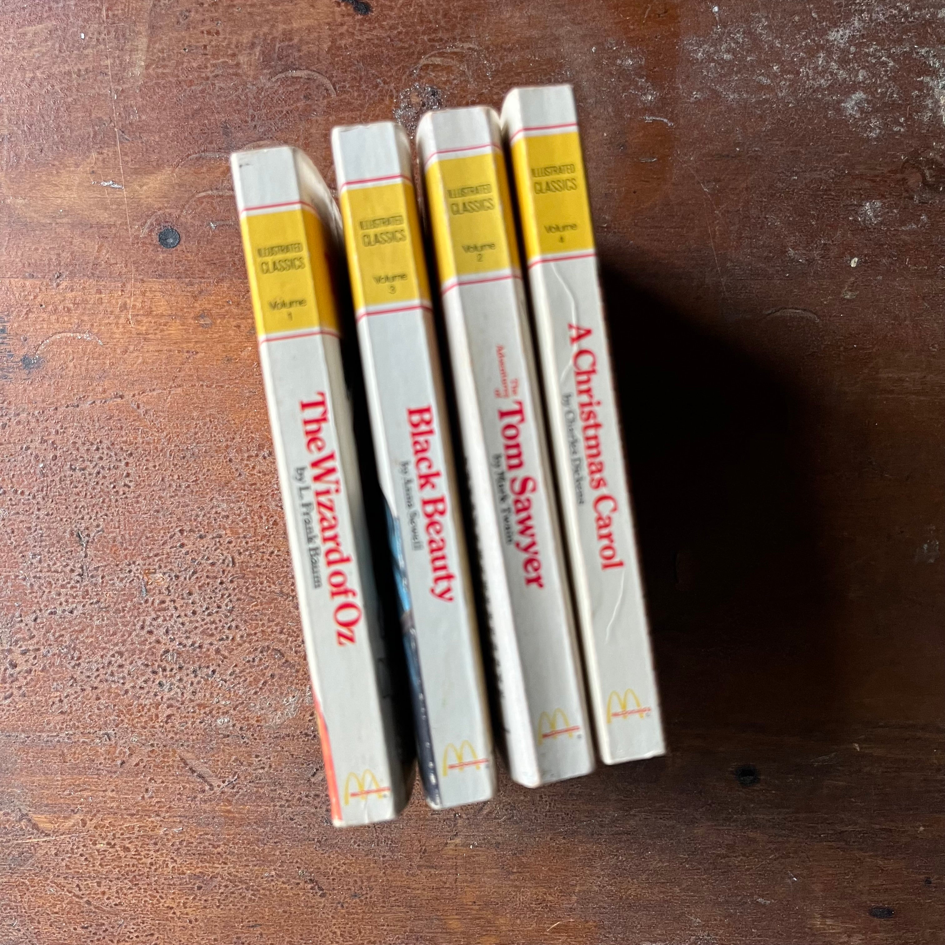 vintage children's chapter books, McDonald's Illustrated Classics - Set of 4 McDonald's Illustrated Classics Books:  The Wizard of Oz, The Adventures of Tom Sawyer, Black Beauty & A Christmas Carol - view of the spines