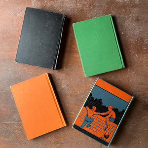 Vintage Schoolbook Set of 4 for Teaching-Learning to Read-Reading for Enjoyment, Friends About Is, City and Country & Pleasant Lands-antiquarian school books-view of the back covers in black, green, orange & a design of a boy sitting on a brick wall helping another boy climb onto the wall in blue, black & orange