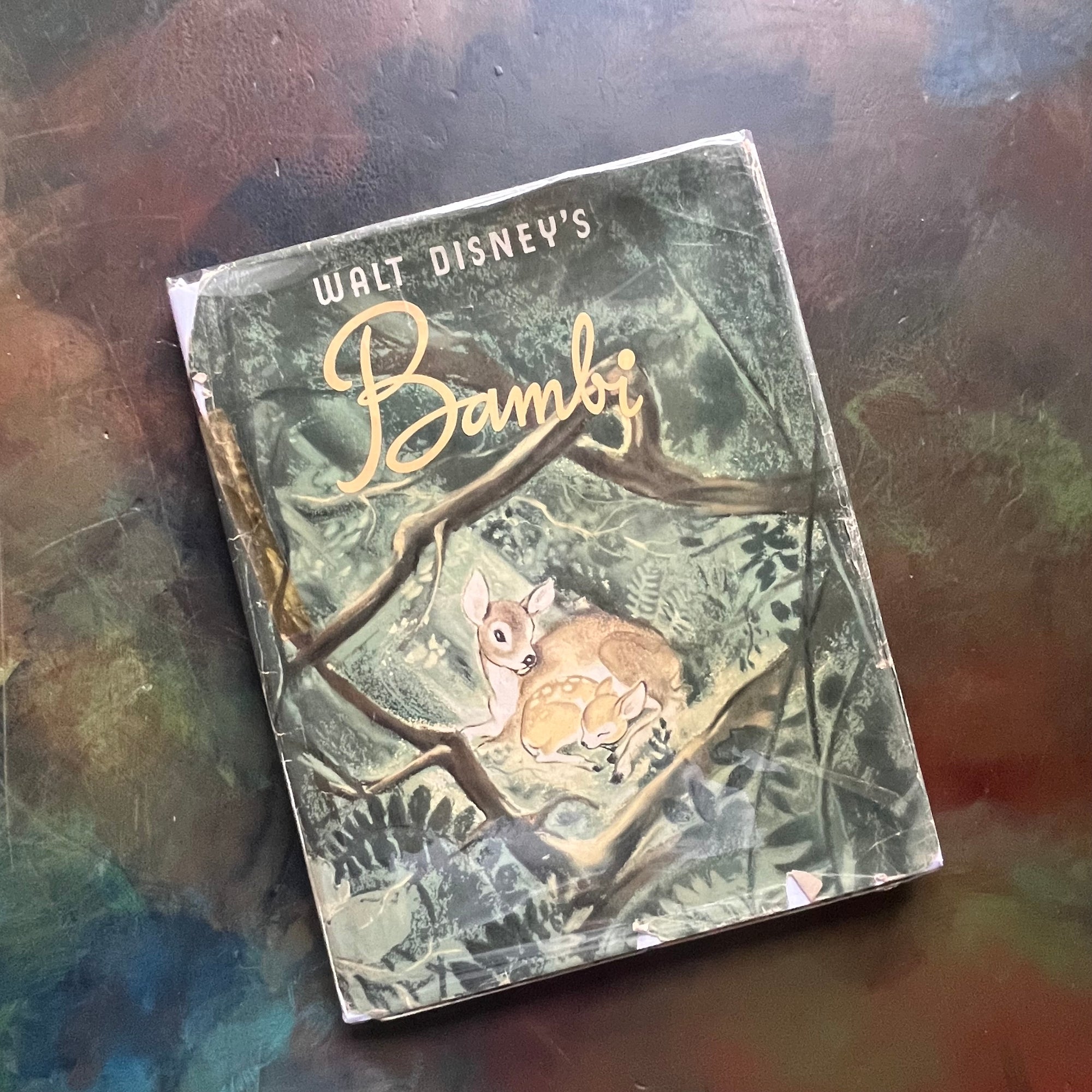 Walt Disney's Bambi- 1941 First Edition-vintage children's picture book-classic children's literature-view of the dust jacket's front cover wrapped in plastic with an image of Bambi as a fawn with his mother