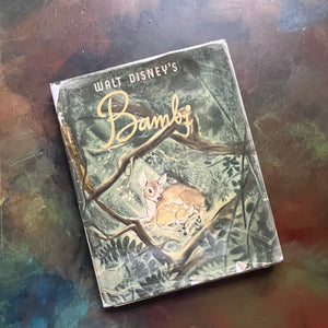 Walt Disney's Bambi- 1941 First Edition-vintage children's picture book-classic children's literature-view of the dust jacket's front cover wrapped in plastic with an image of Bambi as a fawn with his mother