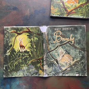 Walt Disney's Bambi- 1941 First Edition-vintage children's picture book-classic children's literature-view of the outside of the dust jacket wrapped in a plastic protective sleeve -note the tears & wear along the edges 