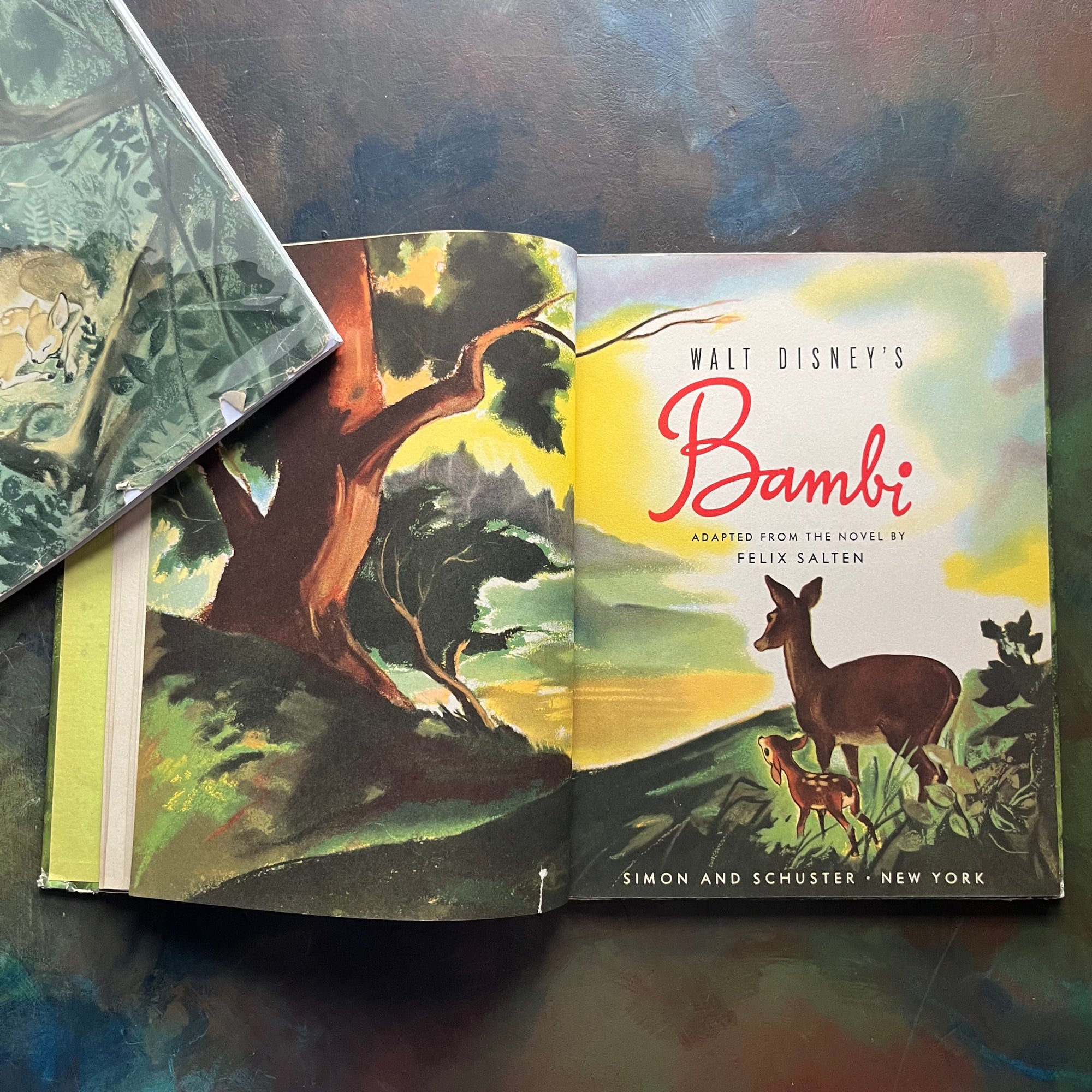 Walt Disney's Bambi- 1941 First Edition-vintage children's picture book-classic children's literature-view of the title & frontispiece piece depicting a colorful scene with bambi & his mother looking out over a lake or valley