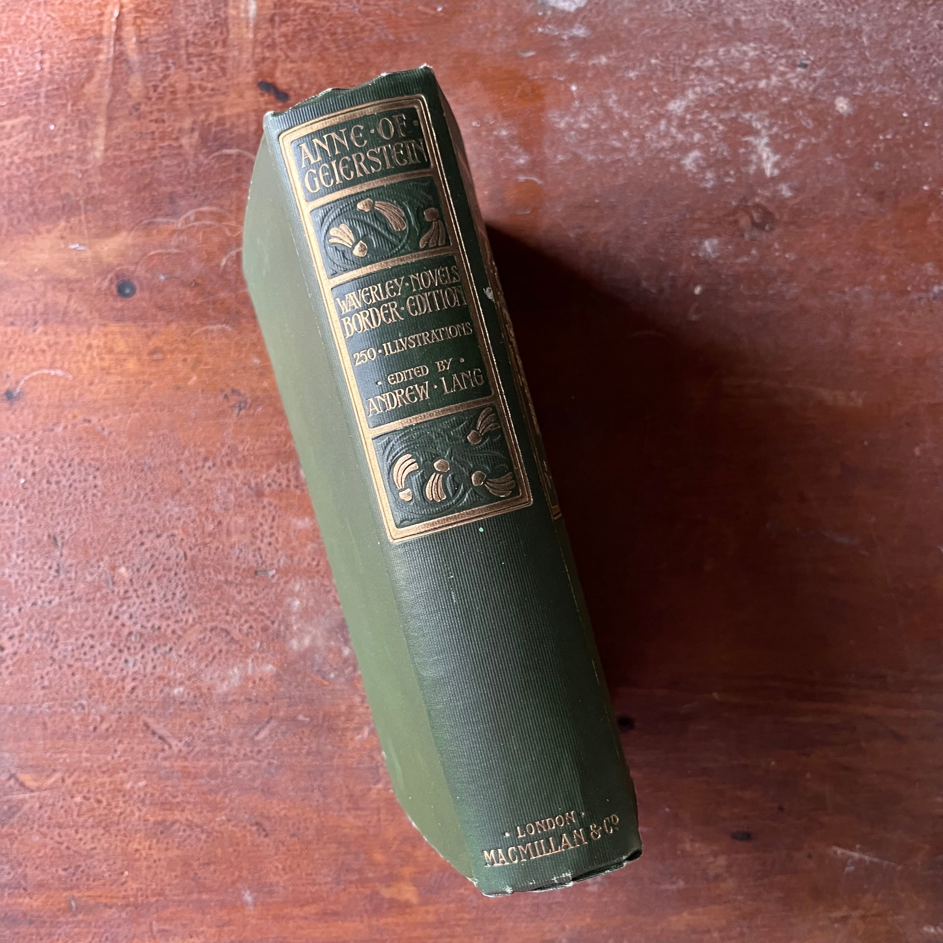 antique book, classic literature - Waverly Novels Border Edition:  Anne of Geierstein written by Sir Walter Scott, Bart. published in 1899-edited by Andrew Lang - view of the embossed spine in green & gold colors