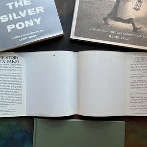Set of three Wordless Picture Books Set–The Silver Pony by Lyn Ward, Unspoken by Henry Cole, and The Story of a Farm by John S. Goodall- Illustrated Children’s Books-view of the condition of the dust jacket - note the age spots and clipped inside flap.