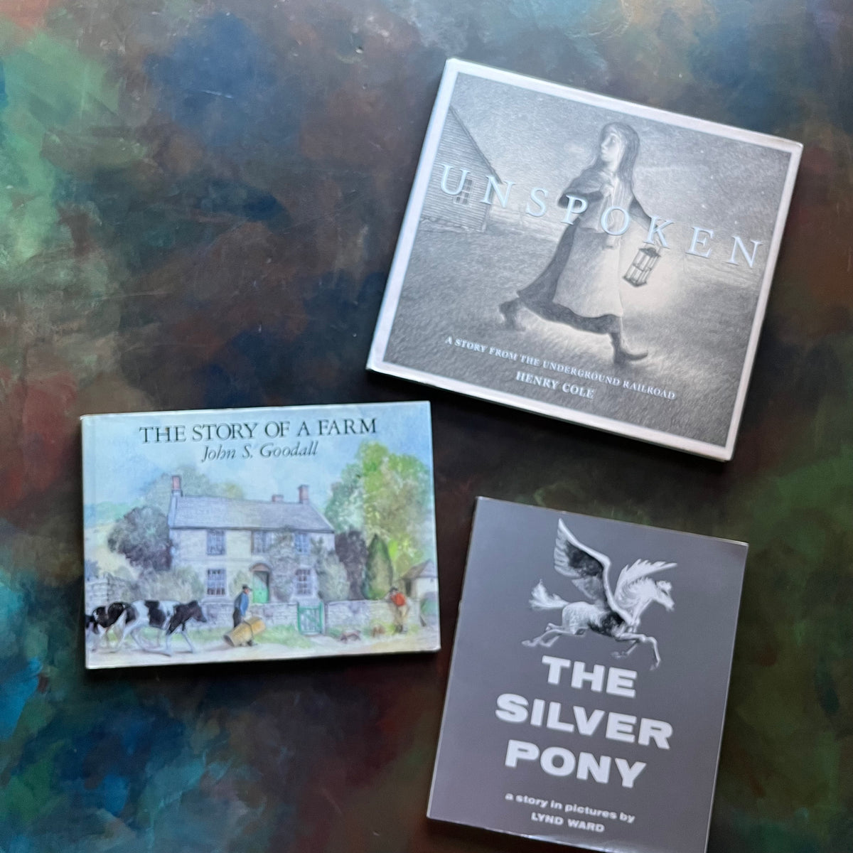 Set of three Wordless Picture Books Set–The Silver Pony by Lyn Ward, Unspoken by Henry Cole, and The Story of a Farm by John S. Goodall- Illustrated Children’s Books-view of the front covers with dust jacket on The Story of a Farm