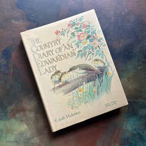 vintage nature sketchbook & diary - The Country Diary of An Edwardian Lady written & illustrated by Edith Holden-a yearlong nature study of the English Countryside from 1906-view of the dust jacket's cover depicting a bird feeding her young.