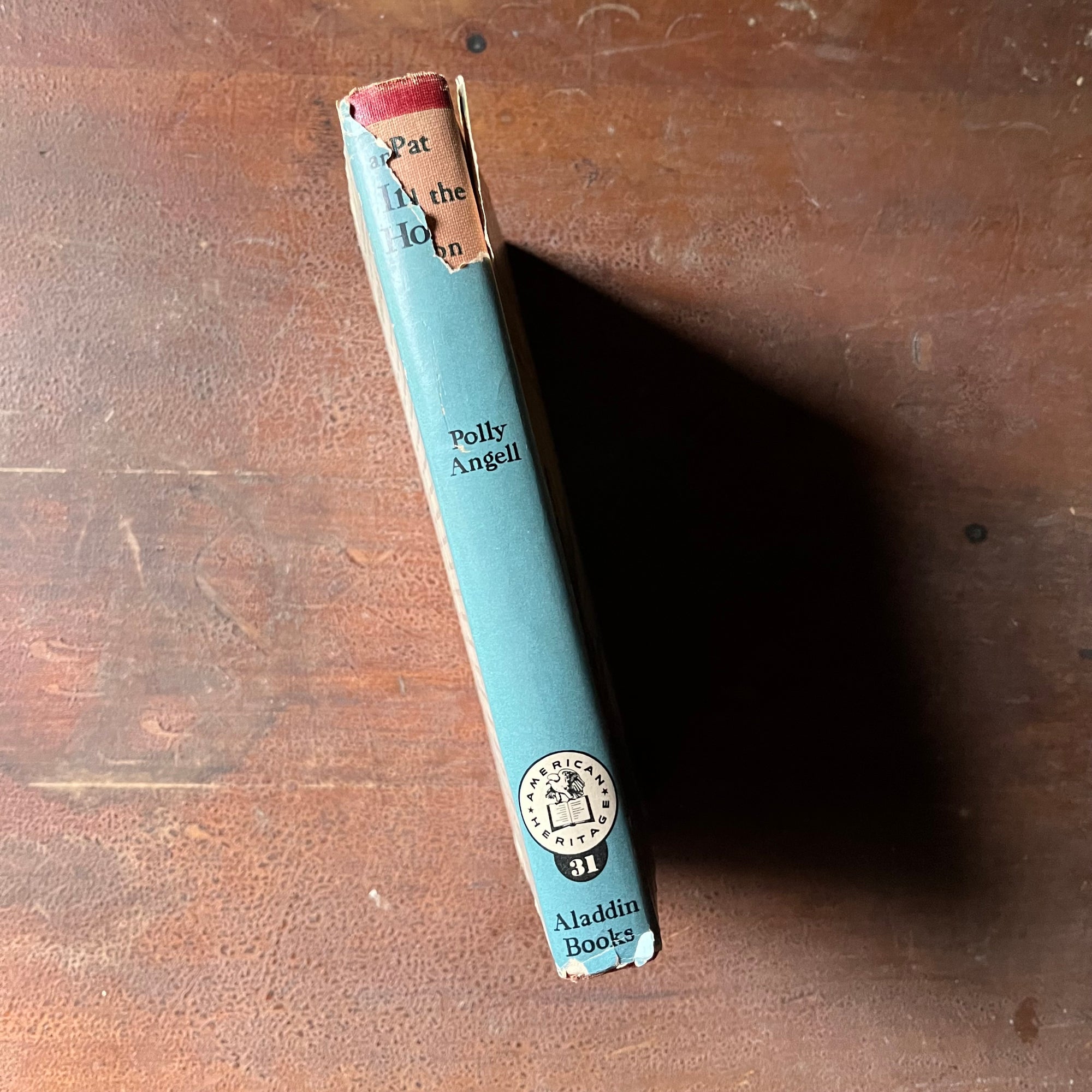 Log Cabin Vintage – vintage children’s book, children’s book, chapter book, American Heritage Series – Pat and the Iron Horse New Americans in the 1840's written by Polly Angell with illustrations by Clifford J. Schule - view of the condition of the dust jacket's spine
