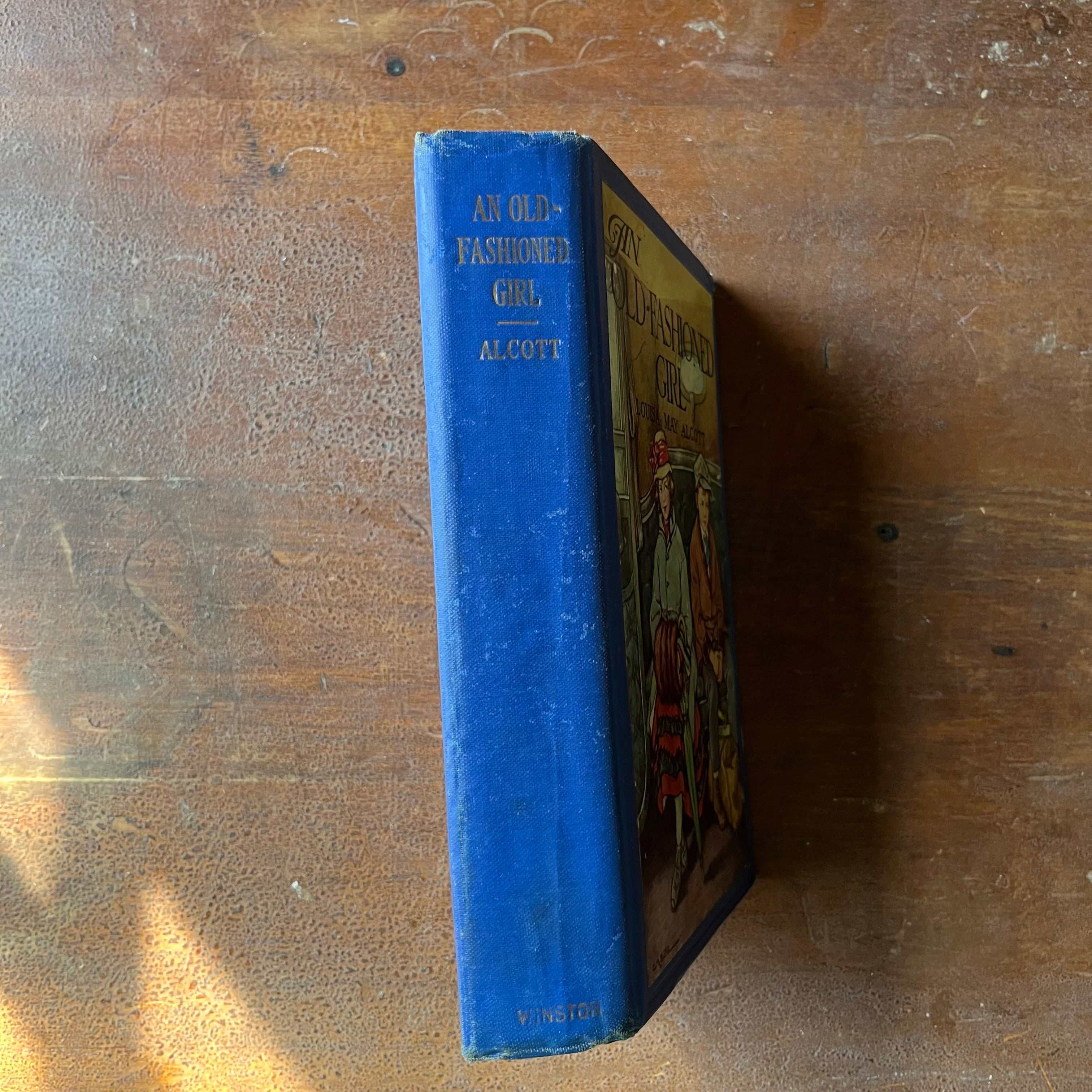 Log Cabin Vintage - vintage children's book, classic literature, vintage chapter book - An Old Fashioned Girl by Louisa May Alcott with illustrations by Clara M. Burd - view of the spine with the faded title at the top