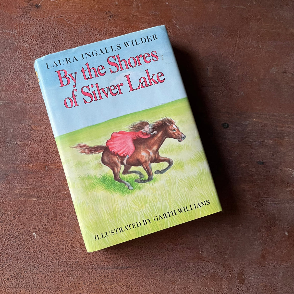 Log Cabin Vintage – vintage children’s book, children’s book, chapter book, Little House on the Prairie Series – By the Shores of Silver Lake by Laura Ingalls Wilder with Illustrations by Garth Williams - view of the dust jacket's front cover