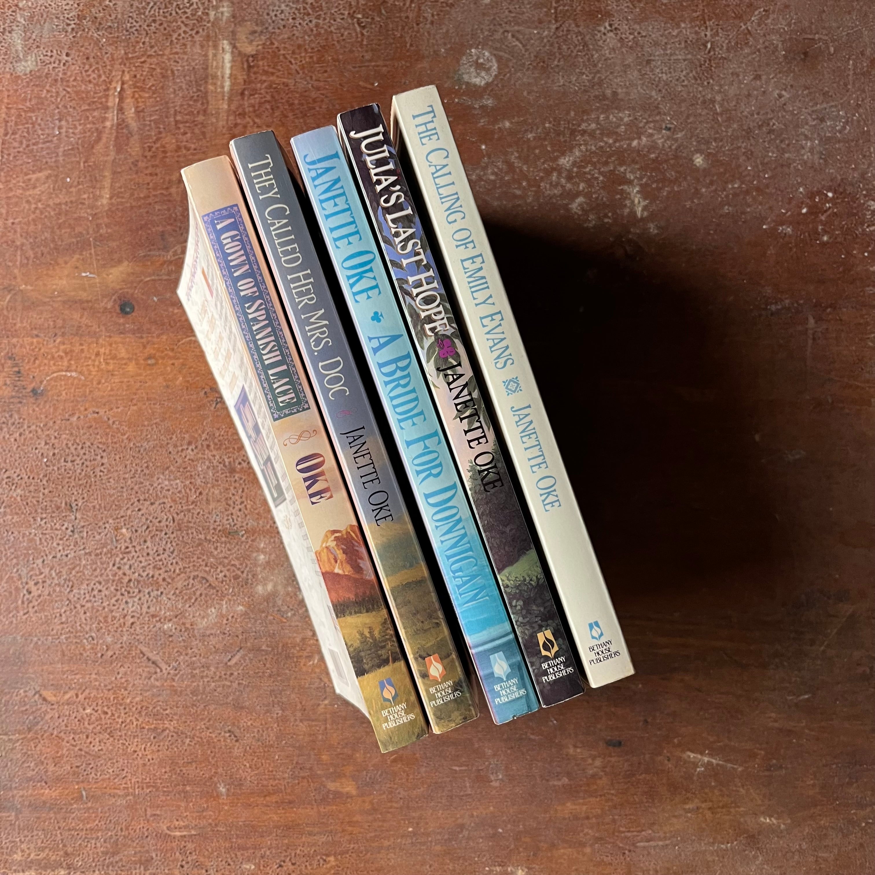 Log Cabin Vintage - Christian fiction, Christian Book Series, Christian Authors, Christian Young Adult Books, Janette Oke - A Five Book Set by Janette Oke:  A Gown of Spanish Lace, They Called Her Mrs. Doc, A Bride for Donnigan, Julia's Last Hope, and The Calling of Emily Evans - view of the spines