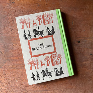 Log Cabin Vintage – vintage children’s book, children’s book, Junior Deluxe Editions – The Black Arrow a 1954 Junior Deluxe Editions Children's Chapter Book sits atop a wood table with the back cover shown