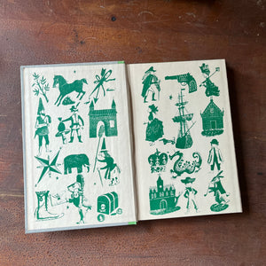 The Black Arrow a 1954 Junior Deluxe Editions Children's Chapter Book sits atop a wood table with the inside cover shown